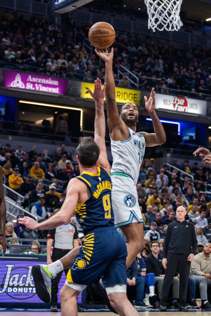 Minnesota Timberwolves forward TJ Warren (24) shoots the ball while Indiana Pacers guard T.J. McConnell (9) defends during the first half at Gainbridge Fieldhouse in Indianapolis on March 7, 2024.